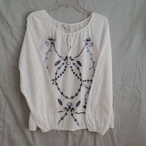 White top with embroidered design with a tie